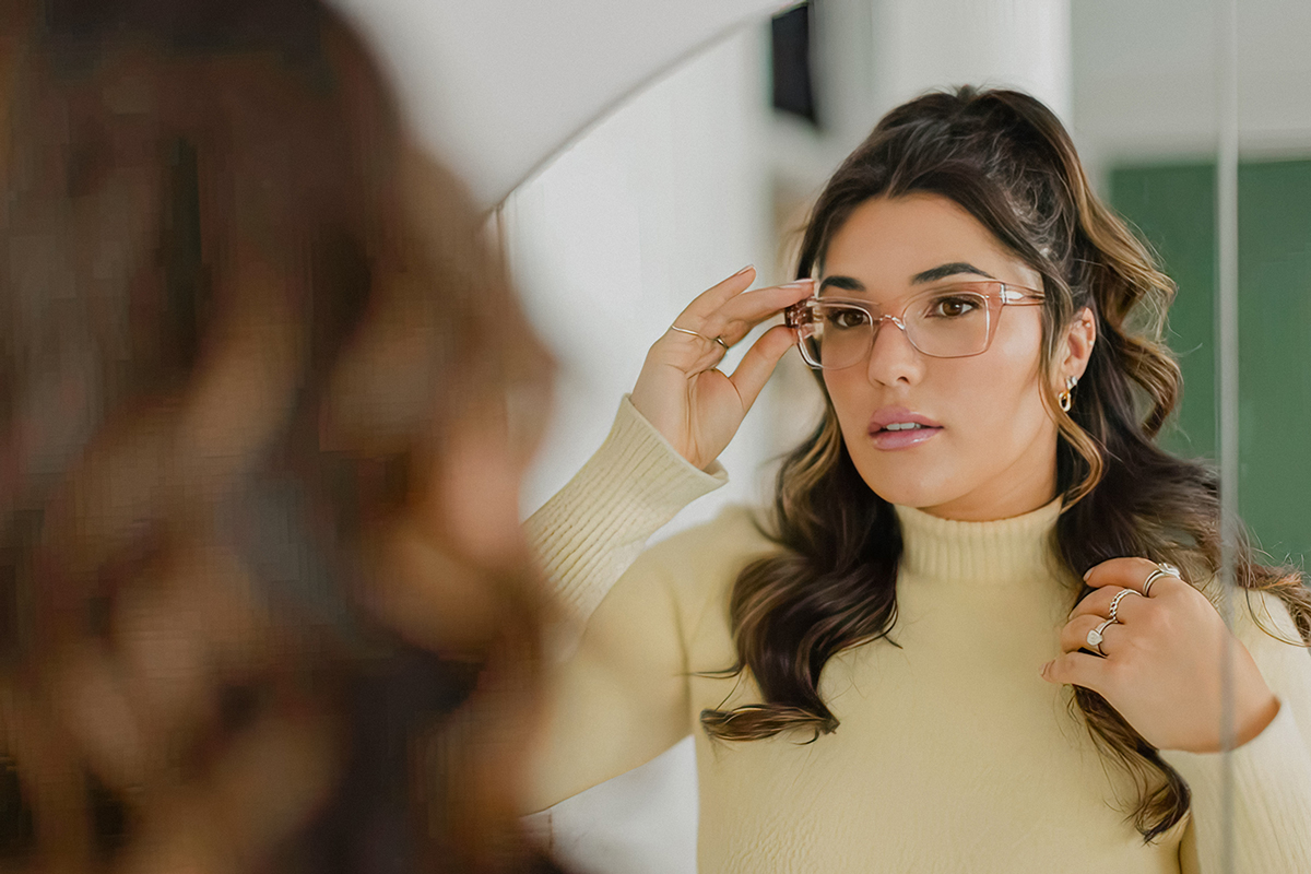 Woman trying on eyewear symbolizing love at first sight with her stylish eyeglasses.